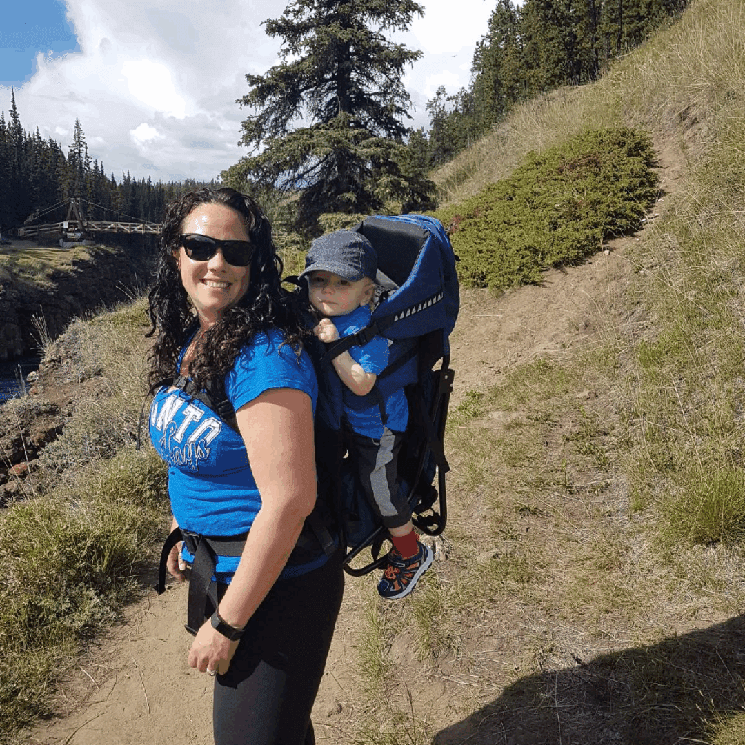 Woman carrying toddler on trail